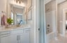 secondary bath with a shower and tub combo