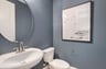 powder room with a pedestal sink and an oval mirror