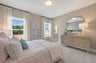 secondary bedroom with carpet and two windows