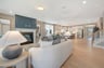 great room with a fireplace and access to kitchen