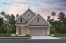 home with brick, windows, garage and landscaping
