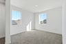 loft with gray carpet, white walls, and two windows