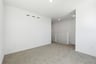 loft with gray carpet, white walls, and view of white staircase railing