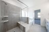 bathroom with walk-in shower with tile 
