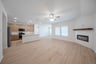 open great room with wood floors and fireplace