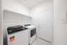 laundry room with tile floors, washer, and dryer