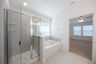 primary bathroom with soaking tub and walk-in shower