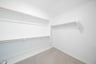 primary bedroom closet with carpet and white shelves