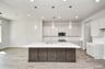 large kitchen island with sink and pendant lights