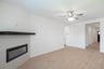 open great room with wood floors and fireplace