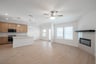 open great room with wood floors and fireplace