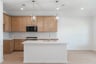 open kitchen with wood floors and island