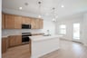 open kitchen with wood floors and island