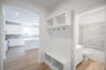 mudroom with white cabinets and shelves