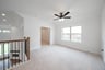 open gameroom with carpet and ceiling fan