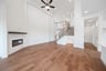 open great room with wood floors and fireplace