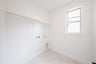 laundry room with tile floors and white shelf