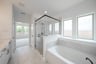 primary bathroom with soaking tub and walk-in shower