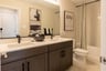 secondary bathroom with dual vanities