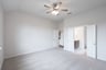 primary bedroom with carpet and ceiling fan