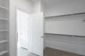 primary bedroom closet with carpet and white shelves