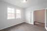 private study with wood floors and windows