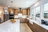 kitchen with white quartz counters and wood-finish cabinets 