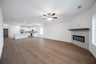 great room with fireplace and ceiling fan 
