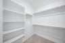 closet with shelves and hanging racks 