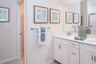 primary bath with white vanities