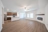 open great room with wood floors and fireplace