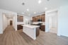 open kitchen with wood floors and island