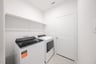 laundry room with tile floors, washer, and dryer
