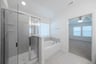 primary bathroom with soaking tub and walk-in shower