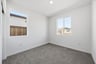 bedroom with gray carpet, white walls, and two windows