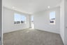 bedroom with gray carpet, white walls, three windows, and recessed ceiling lights