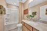 secondary bedroom with a shower and bathtub combo