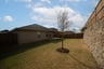 backyard with stone wall and covered patio