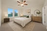bedroom with carpet, windows & a ceiling fan