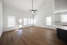 open great room with wood floors and tall ceilings