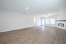 open great room with wood floors and ceiling fan