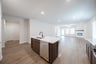 open kitchen with wood floors and island