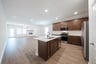 open kitchen with wood floors and island