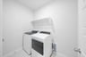 laundry room with tile floors, washer, and dryer