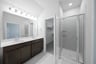 primary bathroom with walk-in shower and tile floors