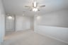 open gameroom with carpet and ceiling fan