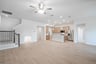 open great room with wood floors and ceiling fan