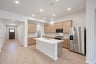 open kitchen with wood floors and island