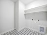 laundry room with white and black flooring