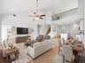 great room with brown floor, dining area and stairs